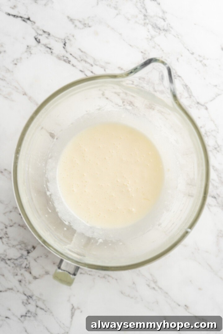 Overhead view of wet ingredients like flax eggs, sugar, and coconut oil in a mixing bowl.