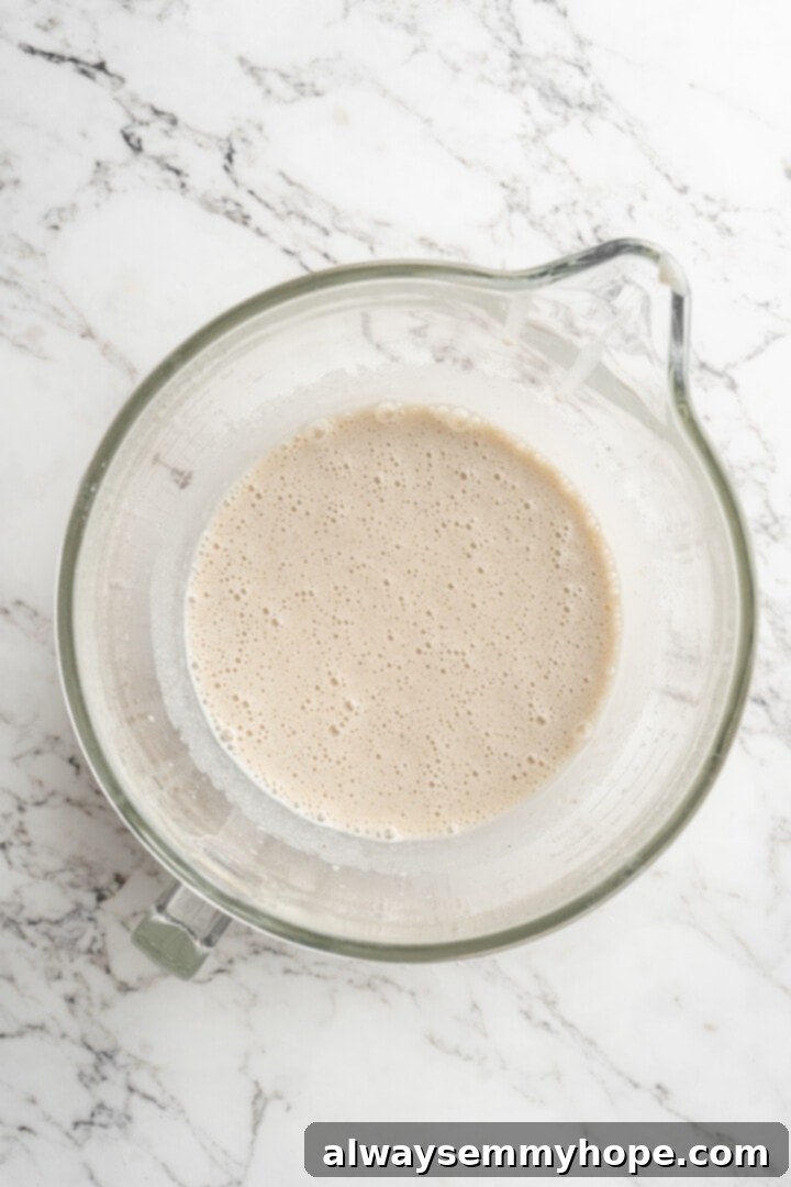 Overhead view of mashed bananas mixed into the wet ingredients for strawberry banana bread.