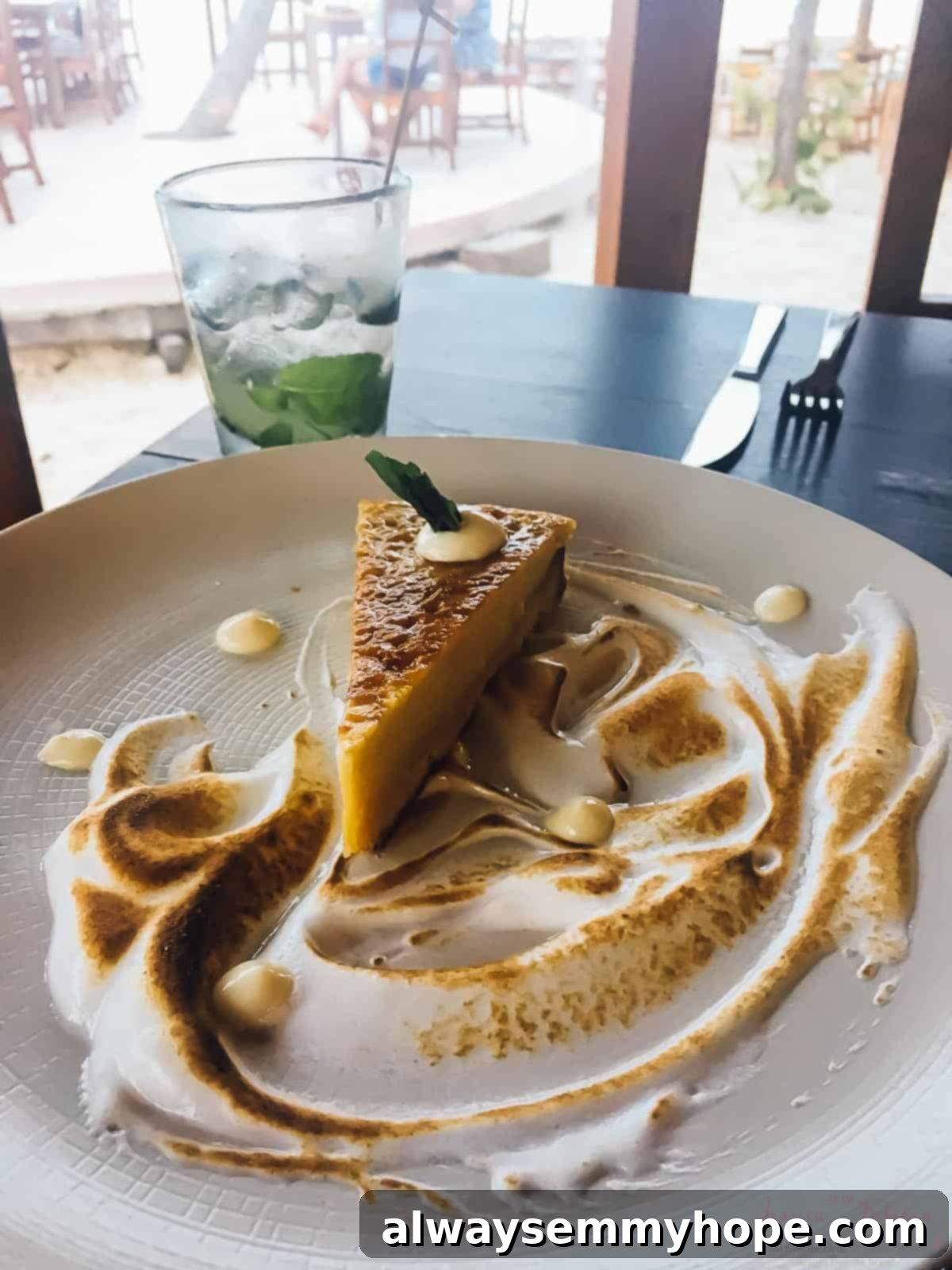 Tulum's Best Eats and Essential City Guide 15 A slice of pie and meringue on a plate in a restaurant.