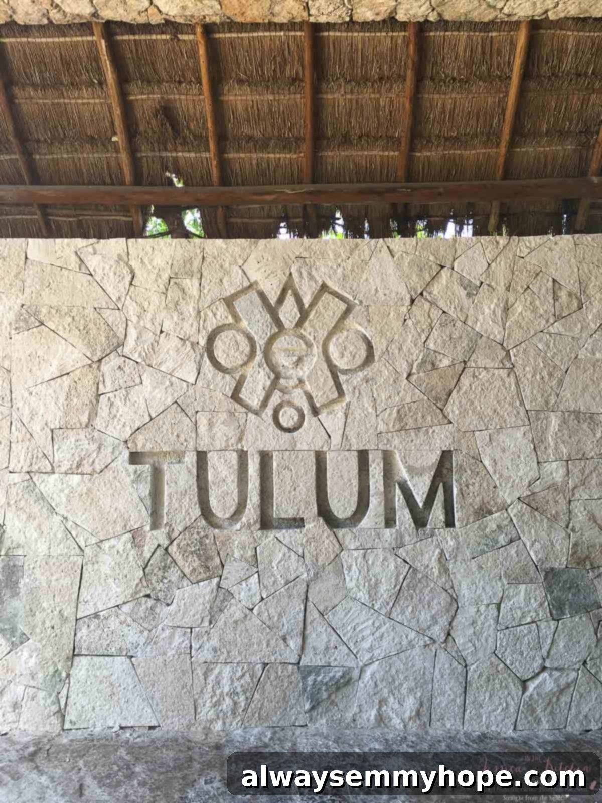 Tulum Eats Your Essential Food and City Guide 19 A rock wall with writing etched into it.