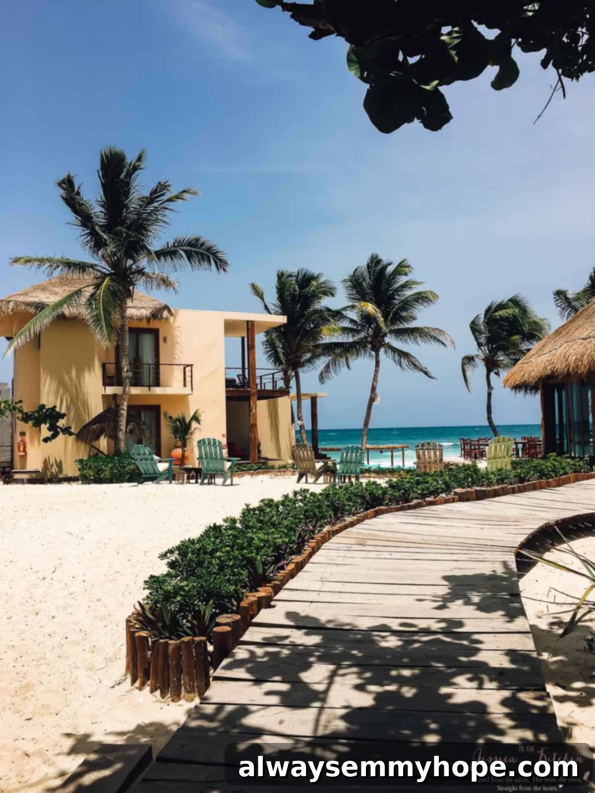 Tulum's Best Eats and Essential City Guide 3 Beach houses under a blue sky.