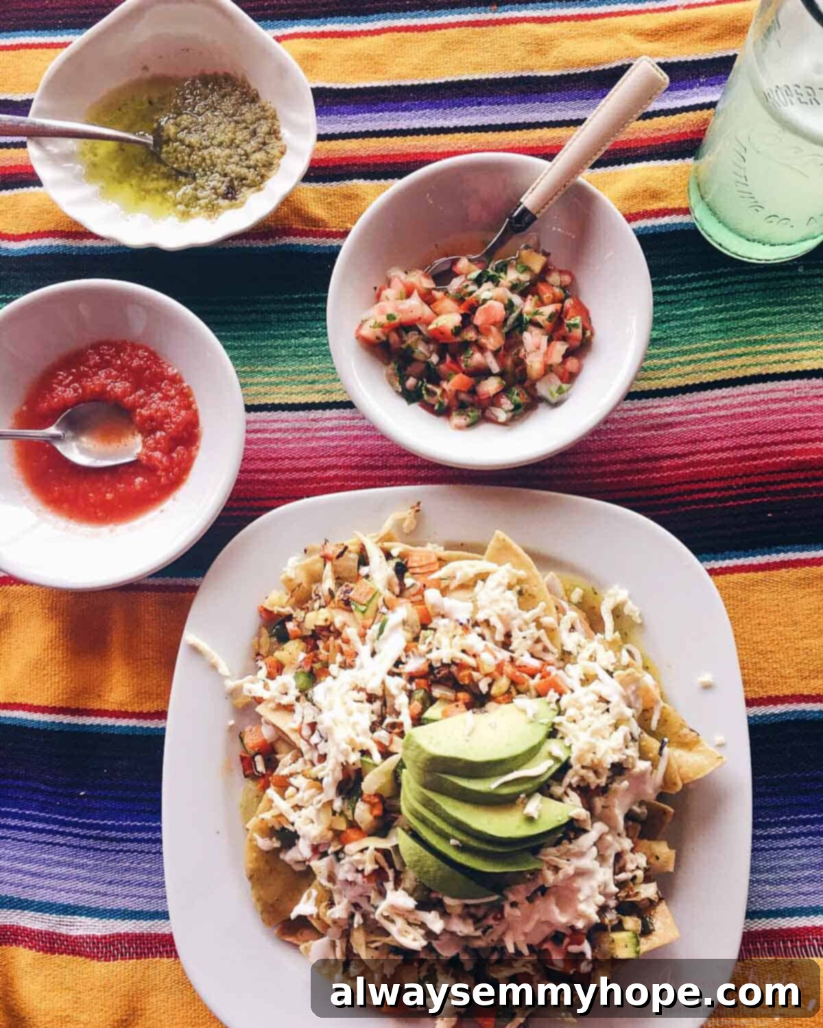 Tulum Eats Your Essential Food and City Guide 8 Overhead shot of cheese, tortillas and sliced avocado on a square plate.