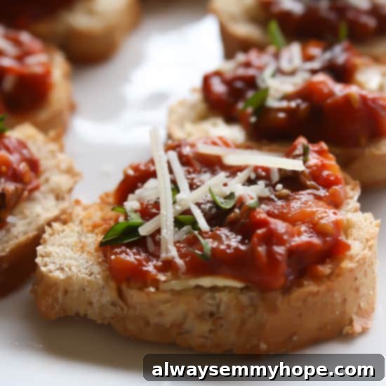 Roasted tomatoes produce an absolutely delicious home-made version of sun-dried tomatoes, resulting in Homemade Sundried Tomatoes Bruschetta. Close up of homemade sundried tomatoes bruschetta on a white countertop.