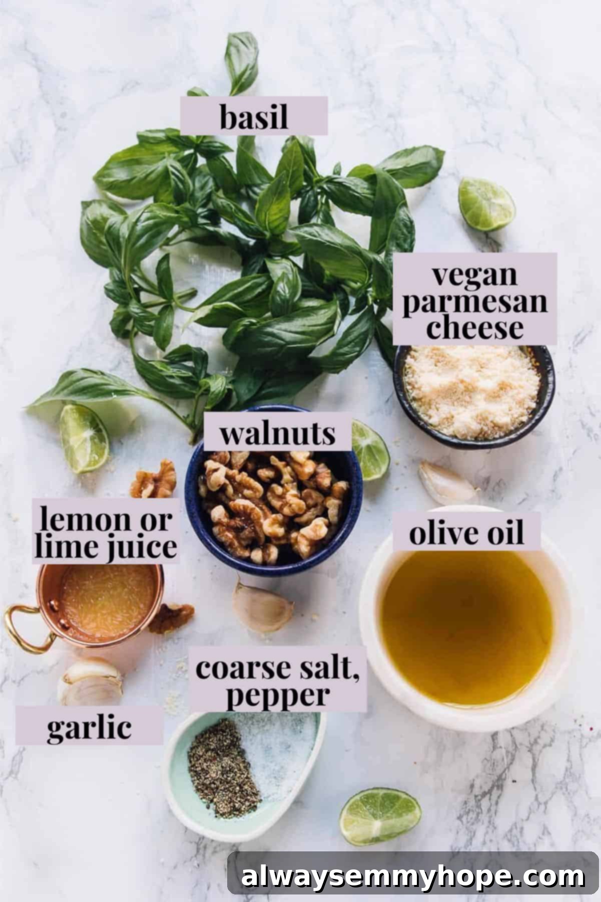 Fresh ingredients laid out for making basil pesto, including basil leaves, walnuts, garlic, and olive oil.