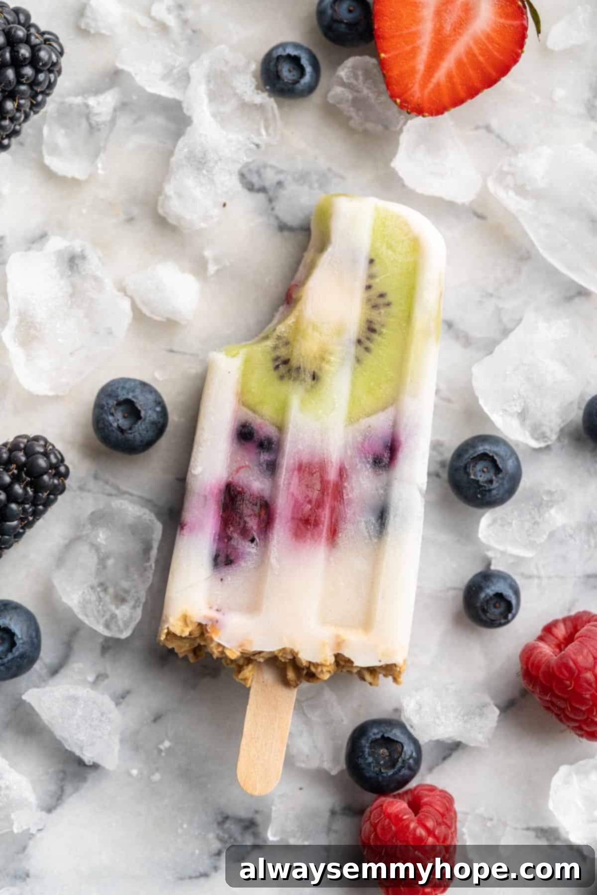 You only need 3 ingredients to make these easy and healthy yogurt popsicles! Enjoy them for breakfast, dessert, or any time in between. Yogurt parfait popsicle with bite taken out of corner