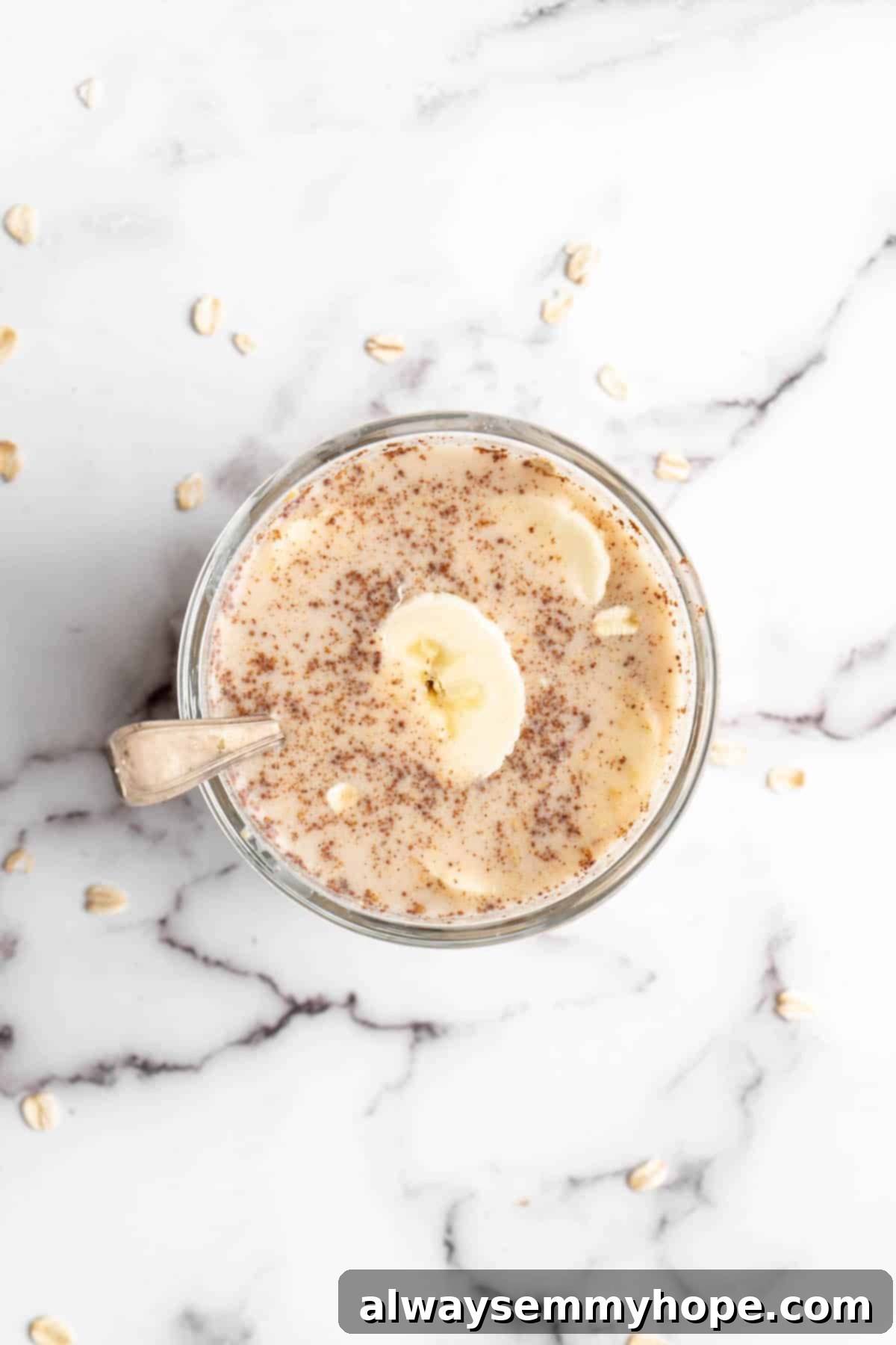 Overhead view of overnight oats in a jar, ready to be eaten with a spoon.