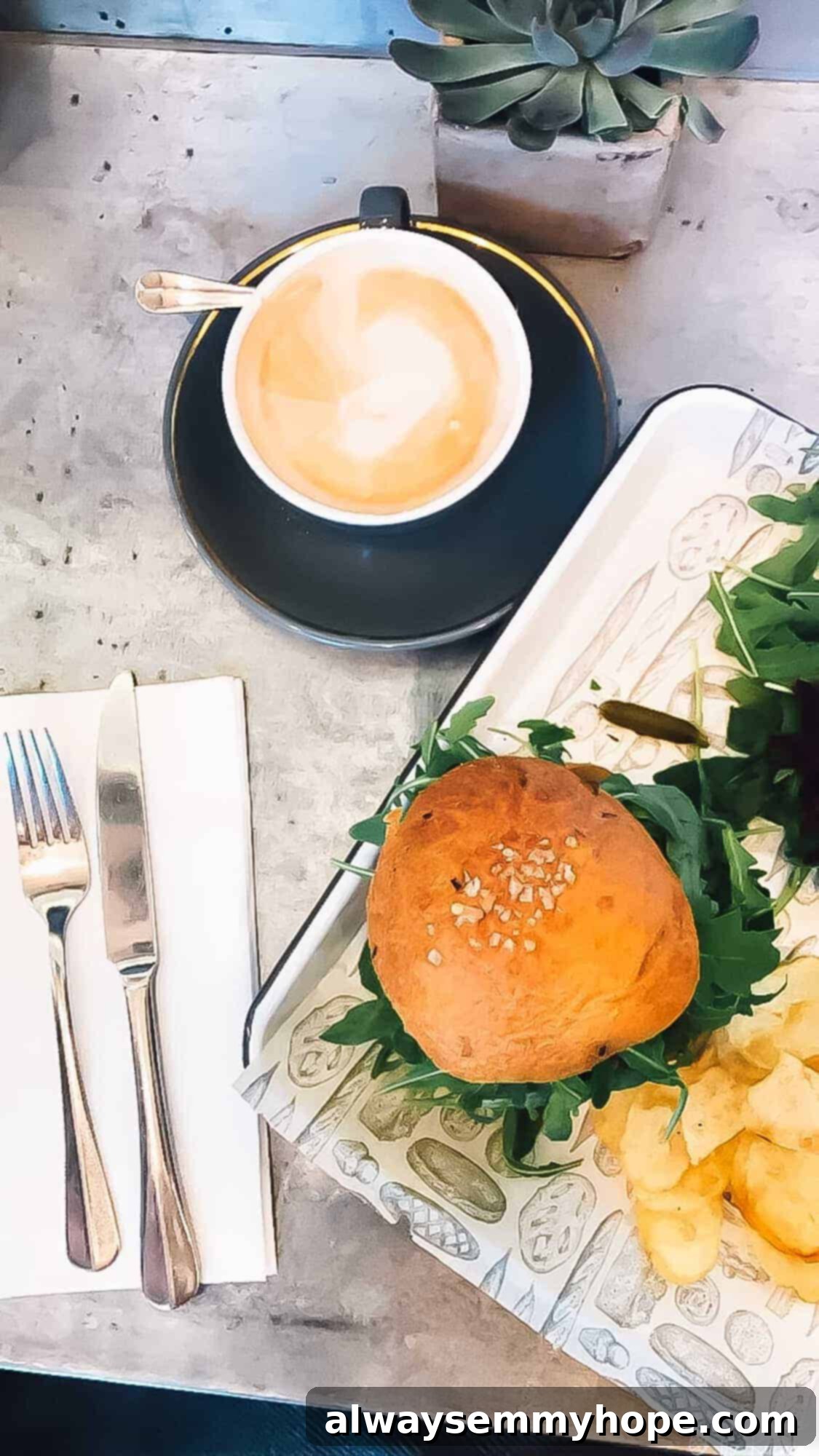 Your Essential Guide to London Food and Exploration 11 Top-down view of a gourmet burger and coffee on a table at a stylish restaurant.