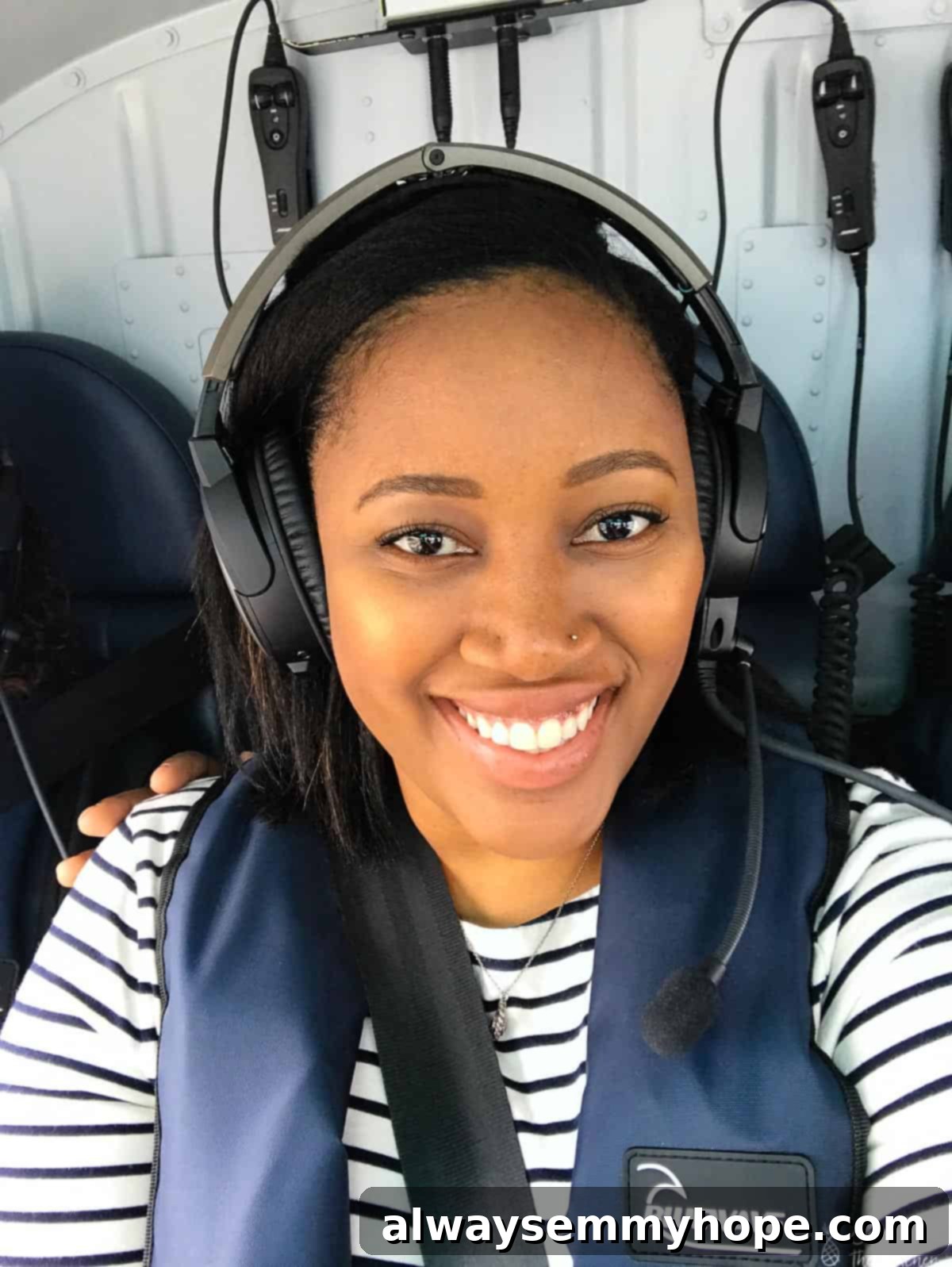 Your Essential Guide to London Food and Exploration 17 Jessica wearing headphones, eagerly looking out from inside a helicopter.