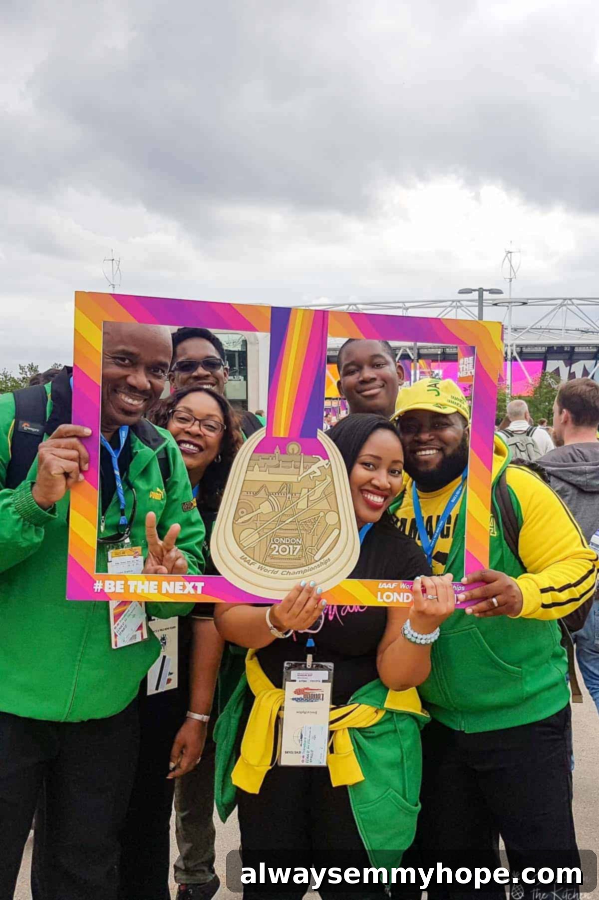 Your Essential Guide to London Food and Exploration 20 Jessica holding up a sign in front of Wembley Stadium in London, England, celebrating the World Championships.