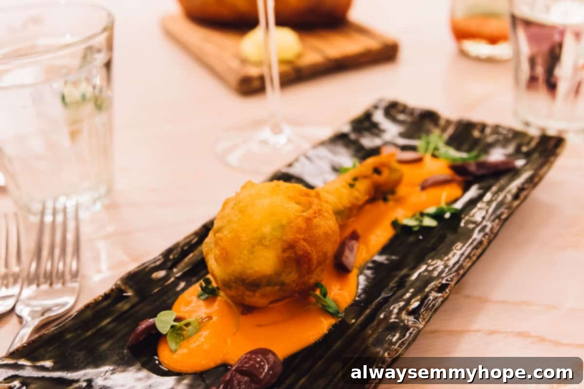 Your Essential Guide to London Food and Exploration 10 Crispy fried zucchini blossoms artfully arranged on a dark dish, a creative appetizer.