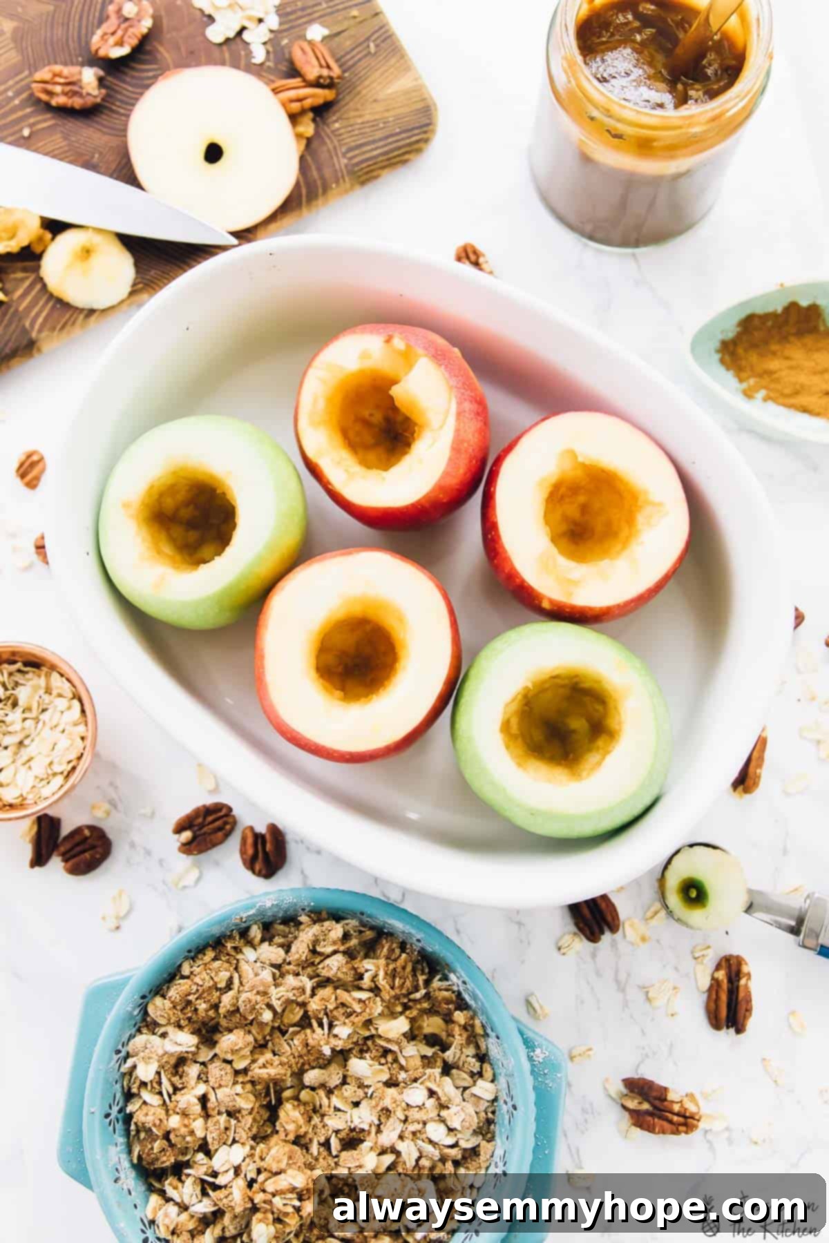 Preparing for a delicious fall dessert: cored apples in a baking dish, ready for their cinnamon oat crisp filling. Top-down view of six cored apples neatly arranged in a baking dish, ready to be filled, with a bowl of a cinnamon oat crisp mixture beside them, showcasing the preparation stage.