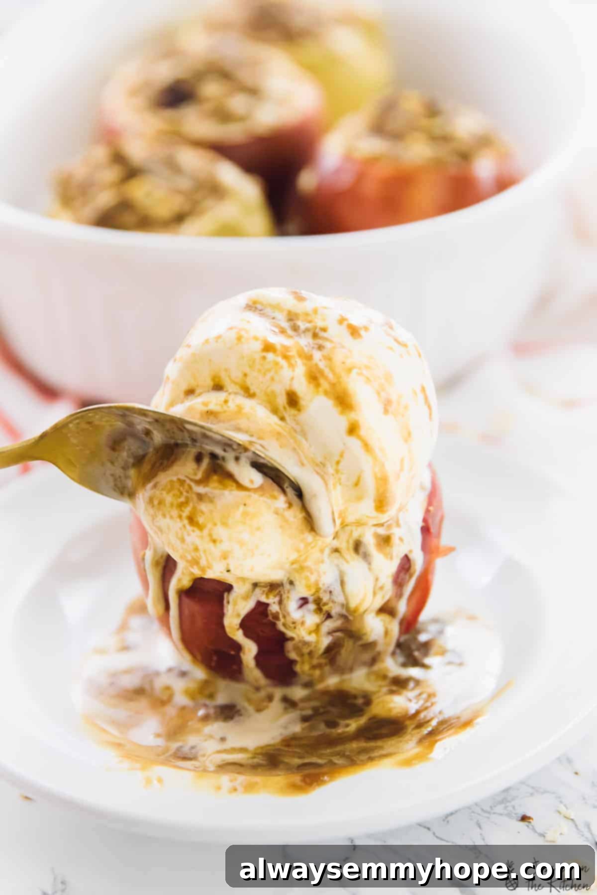 Enjoying a spoonful of baked apple, ice cream, and crisp filling. A spoon cutting into a warm baked apple, revealing the soft interior and the crunchy cinnamon oat crisp filling, with melting ice cream creating a delightful texture contrast.