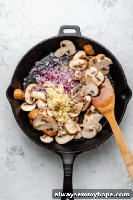 Overhead view of mushroom sauce ingredients in skillet