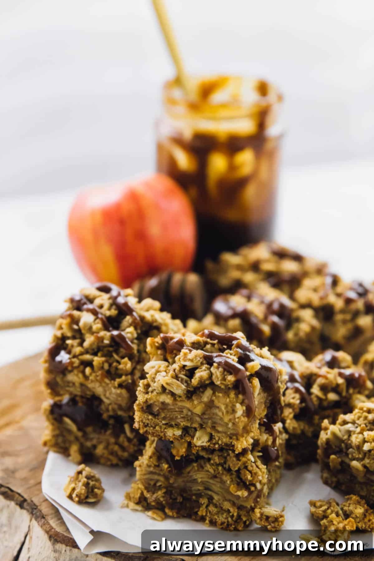 Vegan apple pie bars beautifully arranged on a rustic wood board, showcasing their inviting texture.