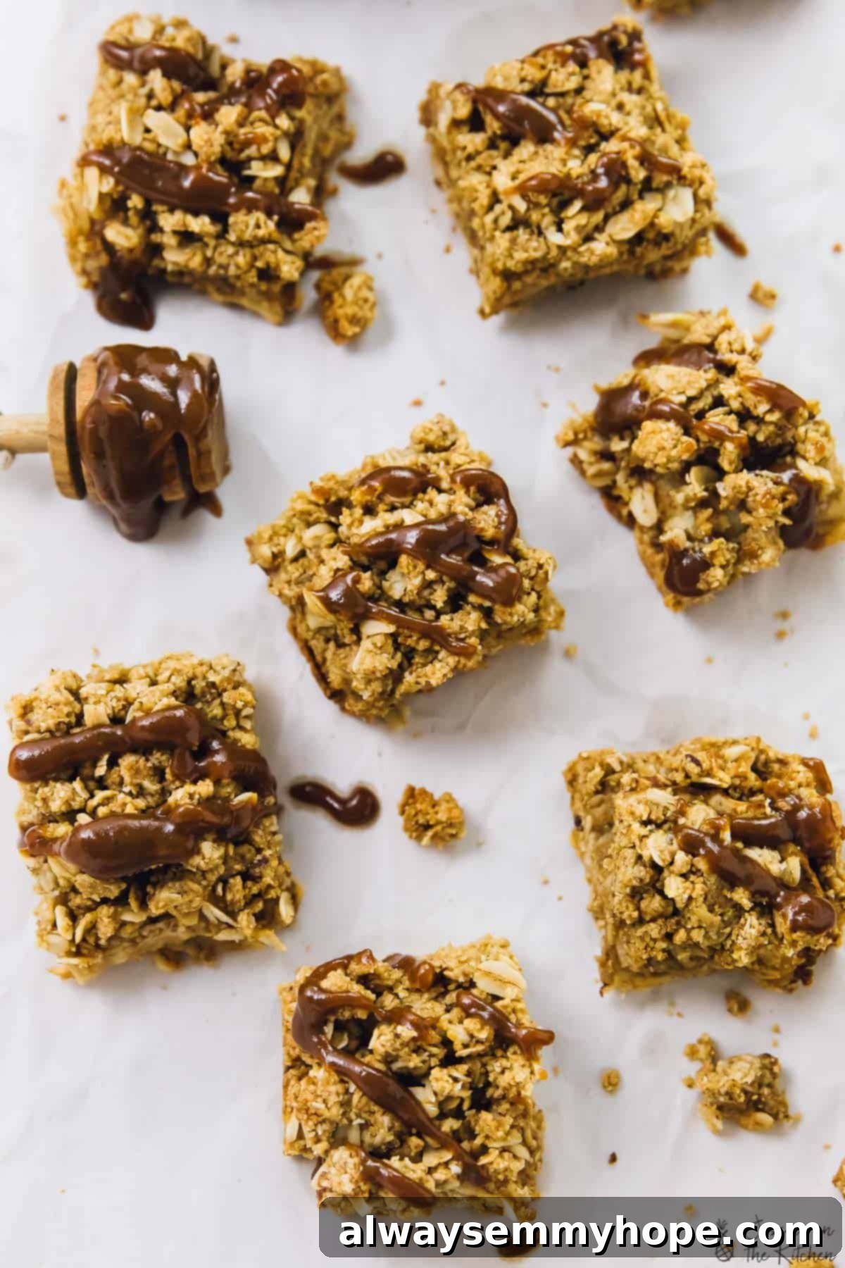 Overhead view of apple pie bars generously drizzled with luscious caramel sauce, ready to be enjoyed.