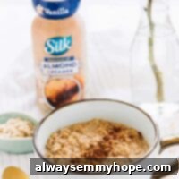 Spiced Espresso Overnight Oats 8 Overnight Oats in a white cup with a bottle of almond creamer in the background.