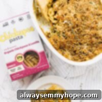Top down view of pasta bake in a white baking dish with a box of pasta on the side.