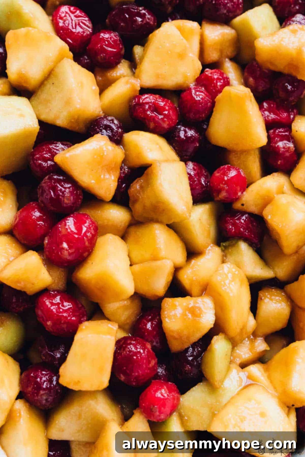 Close-up view of perfectly diced apples and fresh, juicy cranberries, ready to be combined for a delicious crisp filling.