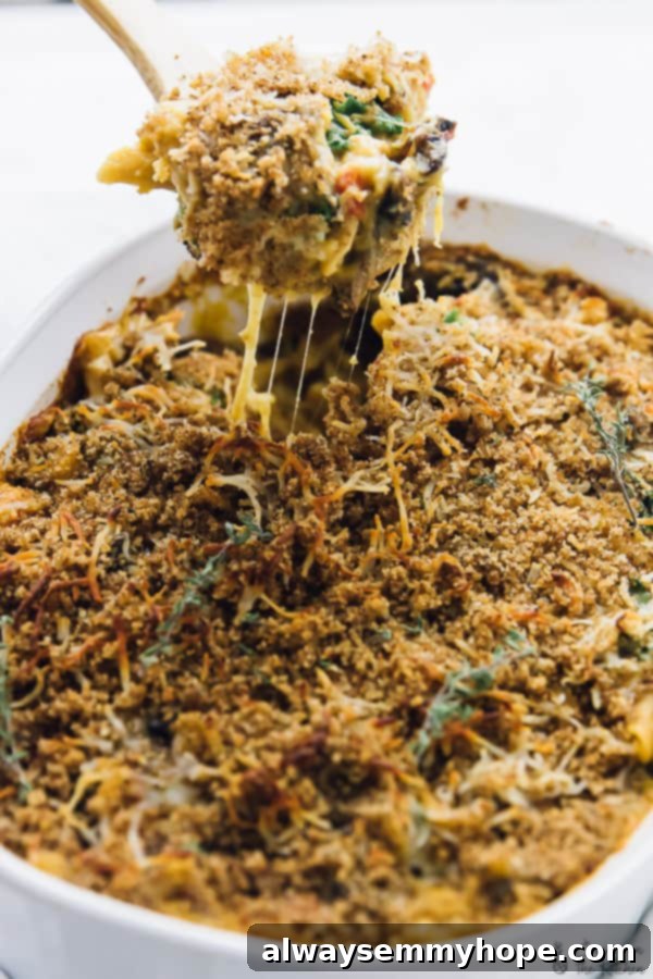 A spoon scooping out some butternut squash casserole form a baking dish.