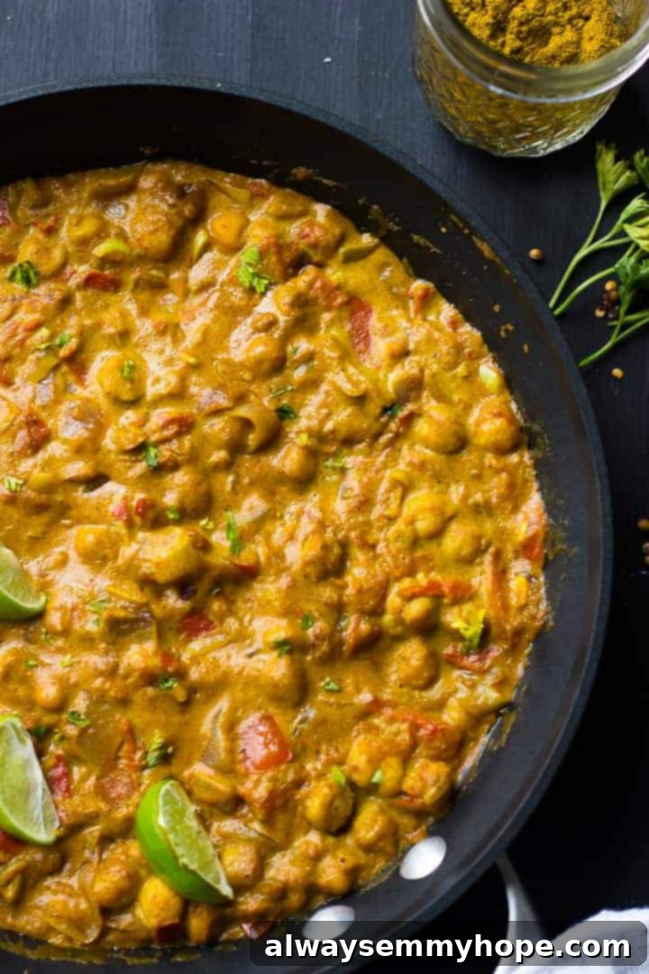 Overhead view of coconut chickpea curry in a black skillet.