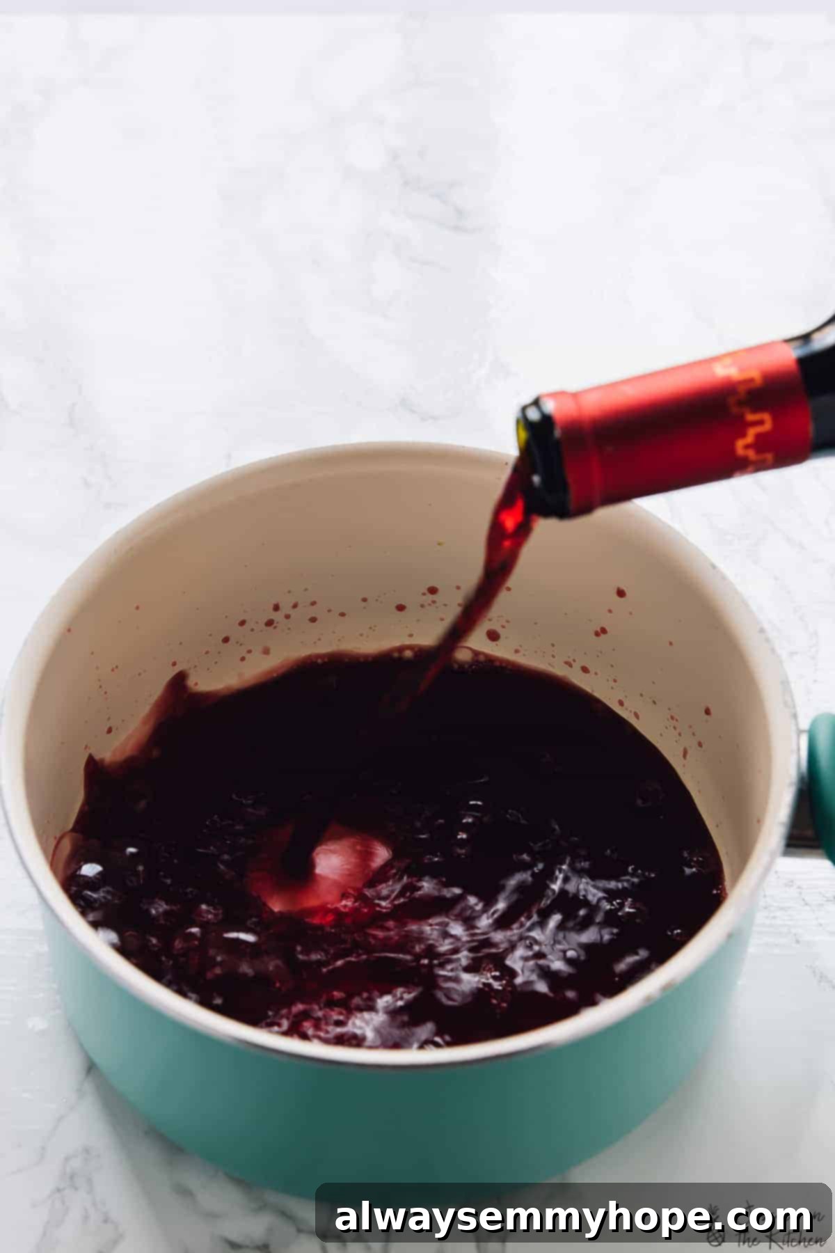 A stream of rich red wine being poured into a vibrant blue mug, with steam gently rising, highlighting the inviting warmth of the drink.
