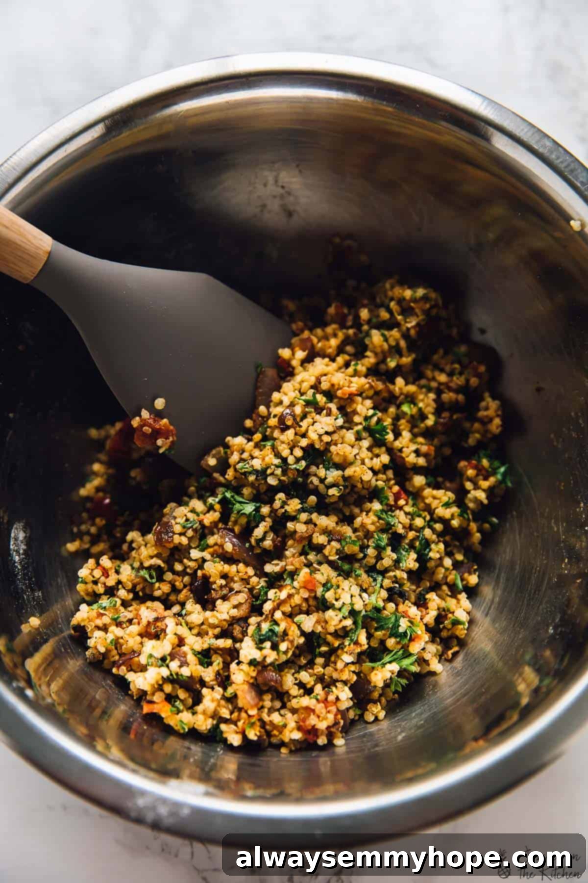 Mixing batter for quinoa patties Close-up shot of a large mixing bowl, where various ingredients for the quinoa patties, including cooked quinoa, chopped vegetables, and binders, are being gently stirred together to create the patty mixture.