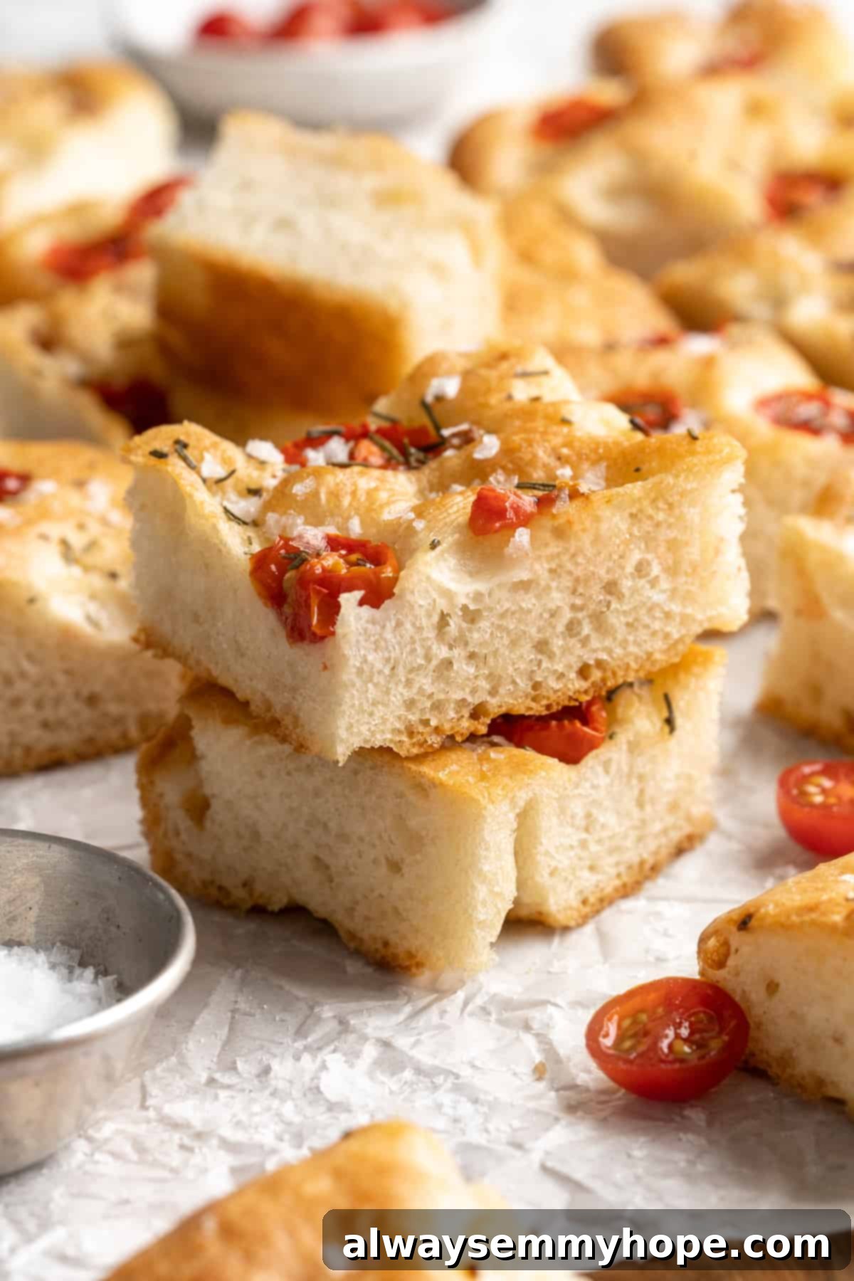 Two pieces of golden-brown gluten-free focaccia stacked on top of each other, showcasing its airy texture and crispy crust.
