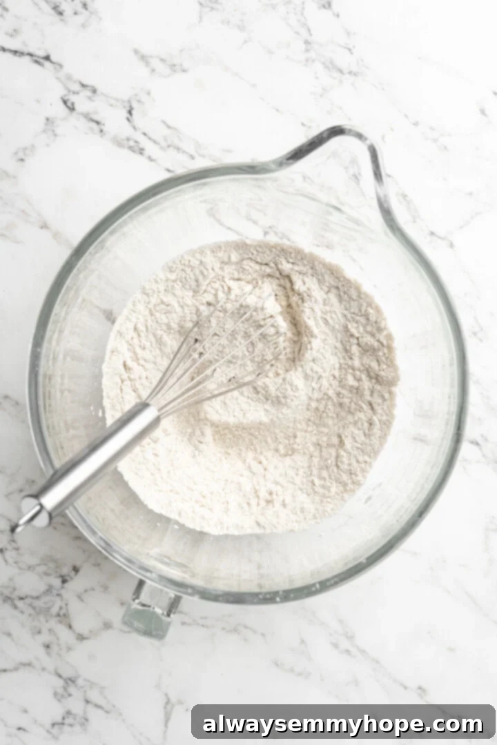 Dry ingredients for gluten-free focaccia neatly arranged in a glass bowl, ready for mixing.
