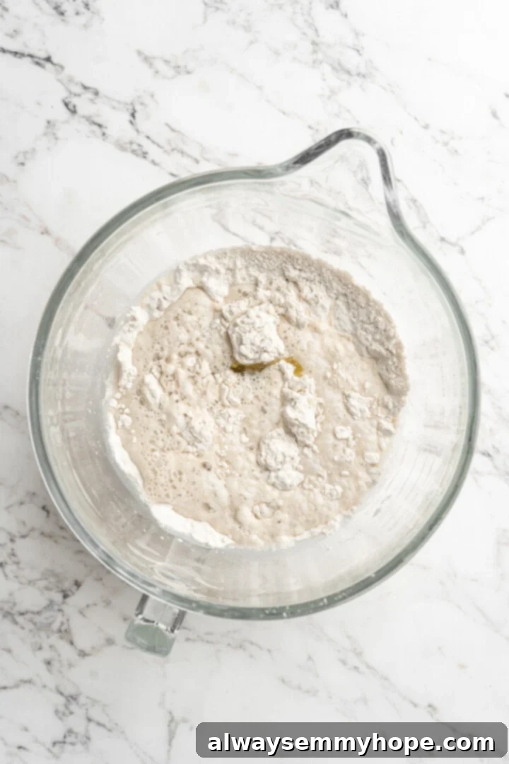Wet and dry ingredients for gluten-free focaccia dough combined in a bowl, just before stirring.