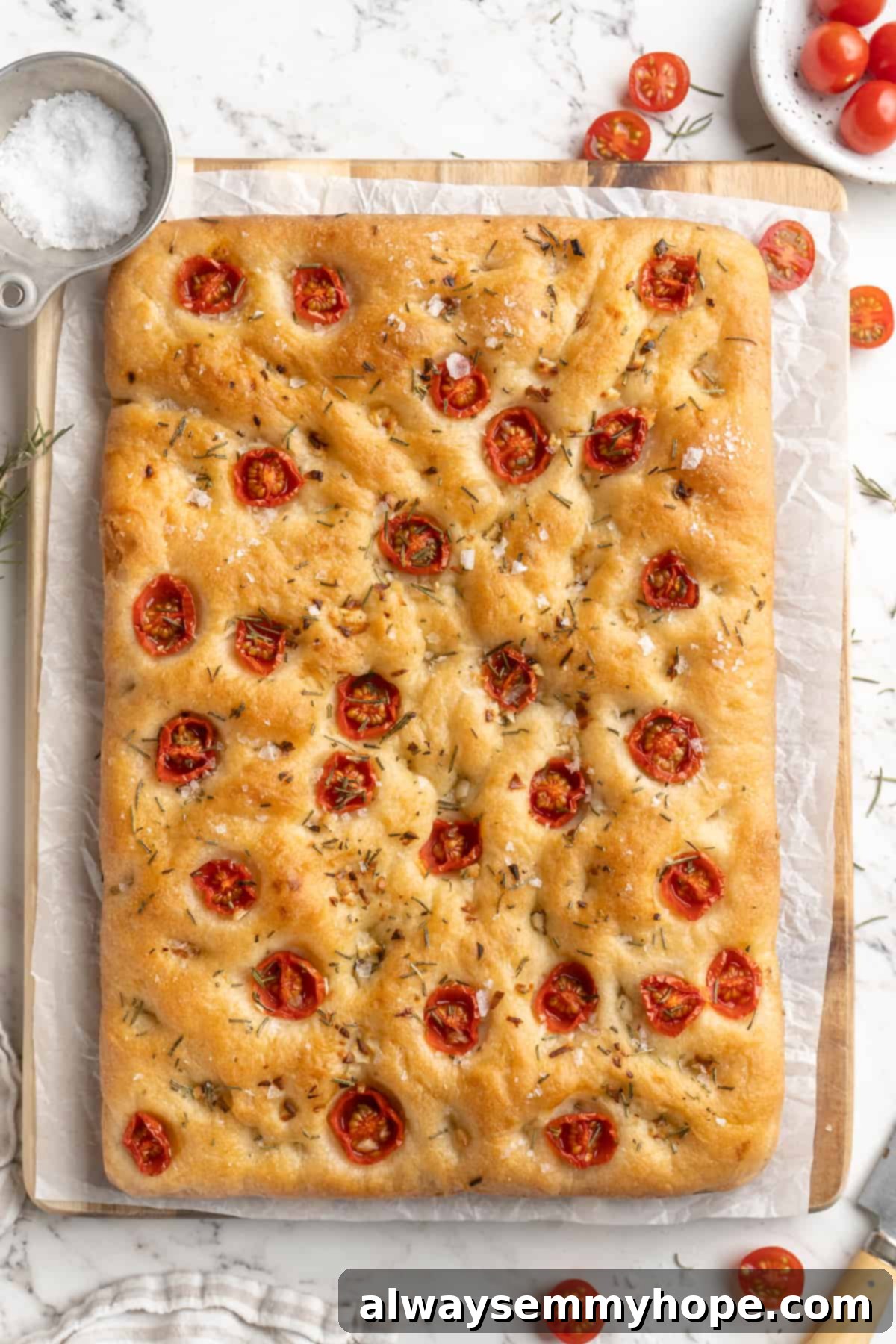 A whole loaf of golden-brown gluten-free focaccia, fresh from the oven, with perfectly baked toppings.