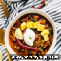 Overhead shot of red lentil chili in a white bowl.