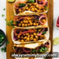 BBQ Chickpea Tacos with Vibrant Kale Cabbage Slaw 2 Overhead view of four BBQ chickpea tacos lined up on wooden cutting board