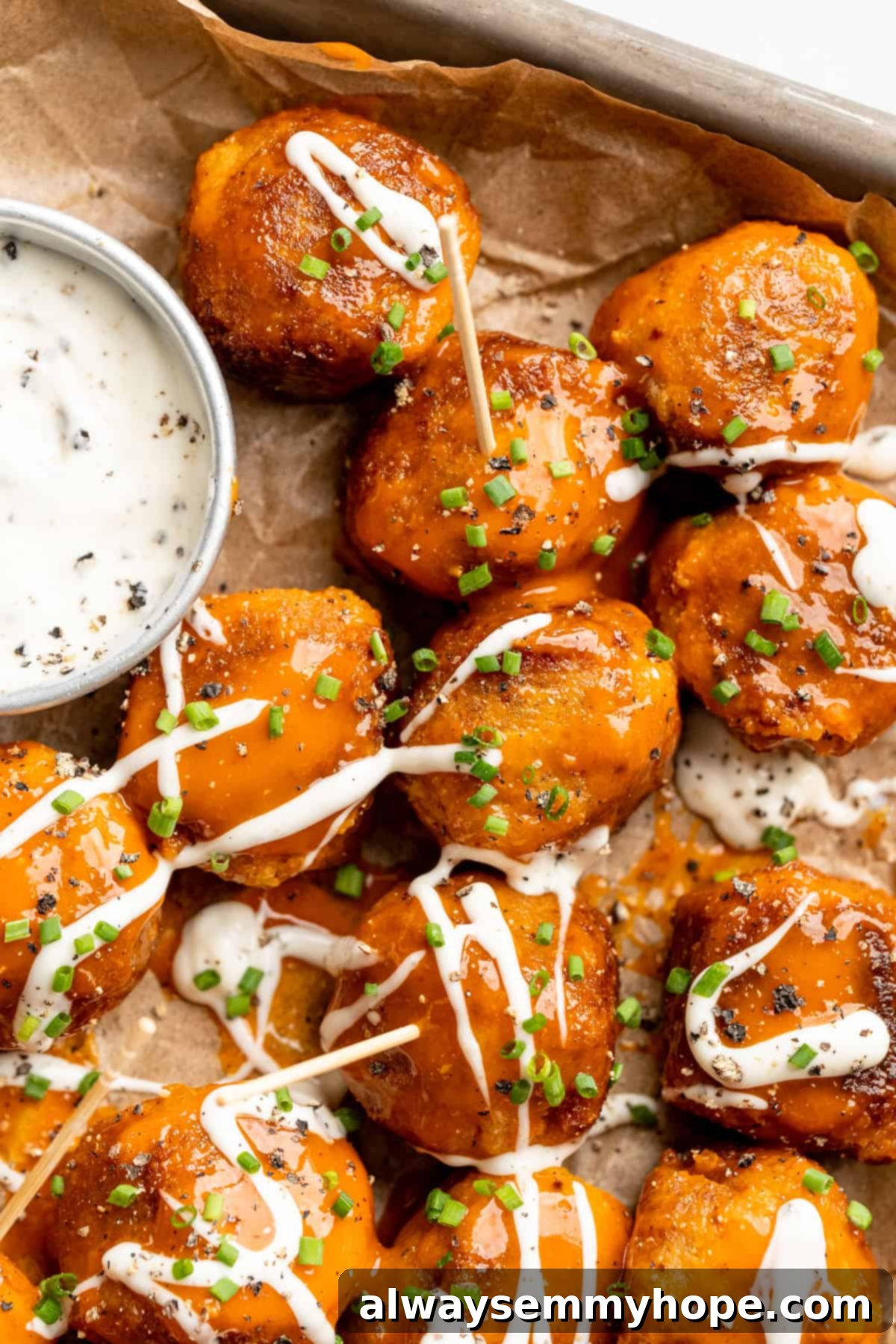 Sheet pan with Buffalo cauliflower meatballs and vegan ranch.