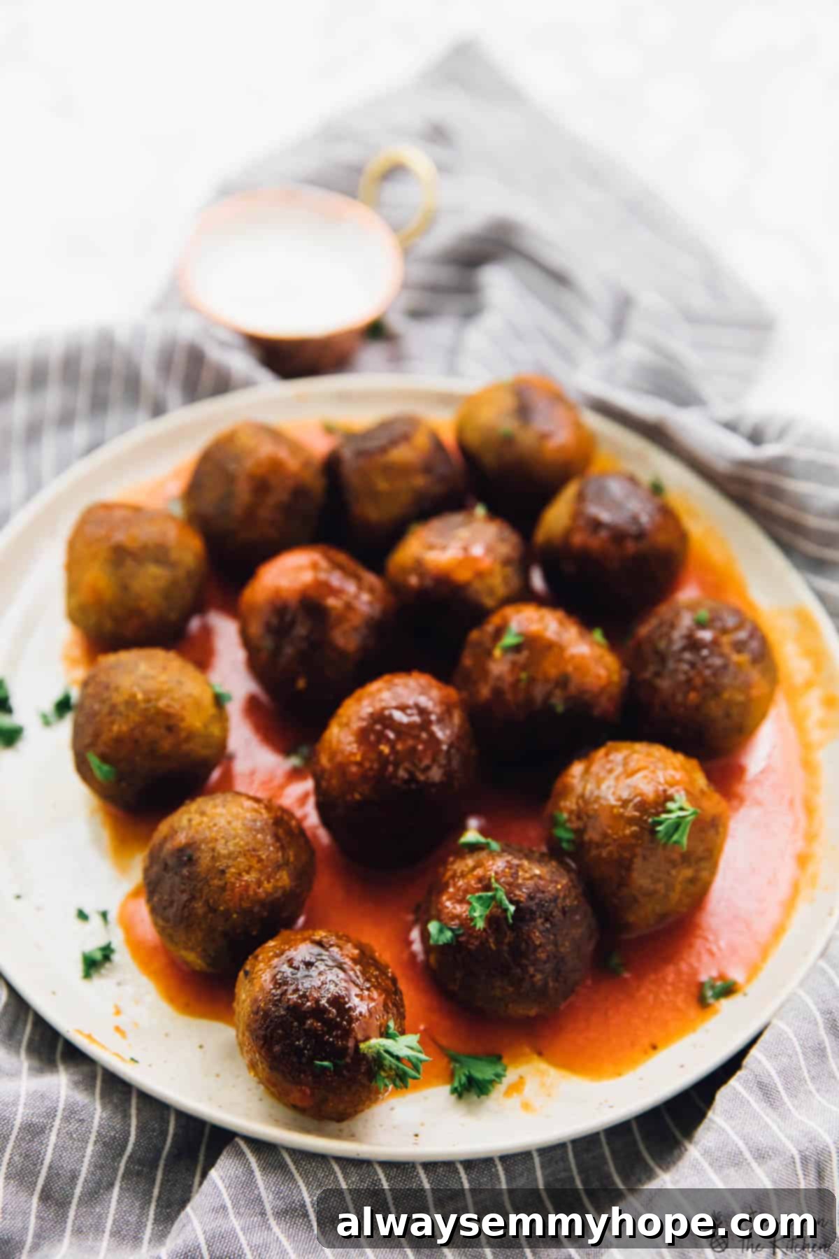 Buffalo-Style Vegan Quinoa Cauliflower Meatballs 3 A plate of vegan meatballs on a white plate.