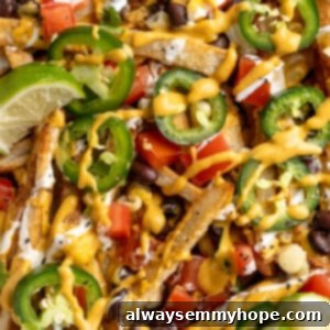 Ultimate Nacho Fries 2 Overhead view of loaded nacho fries topped with vegan queso