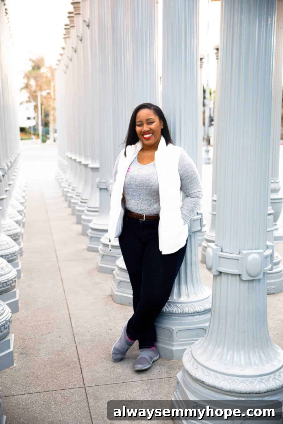Jessica standing in an art installation, smiling to camera.