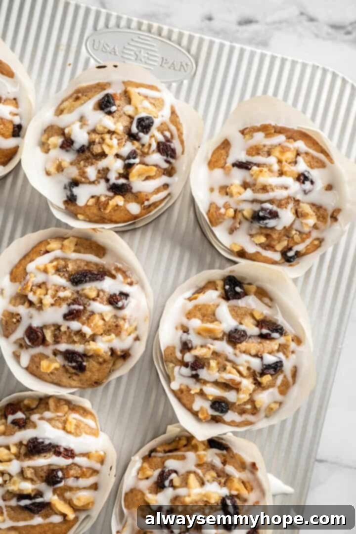 These easy carrot cake muffins bake up in just 30 minutes and are absolutely fantastic. Moist, delectable, vegan and gluten-free! Carrot cake muffins in pan with glaze