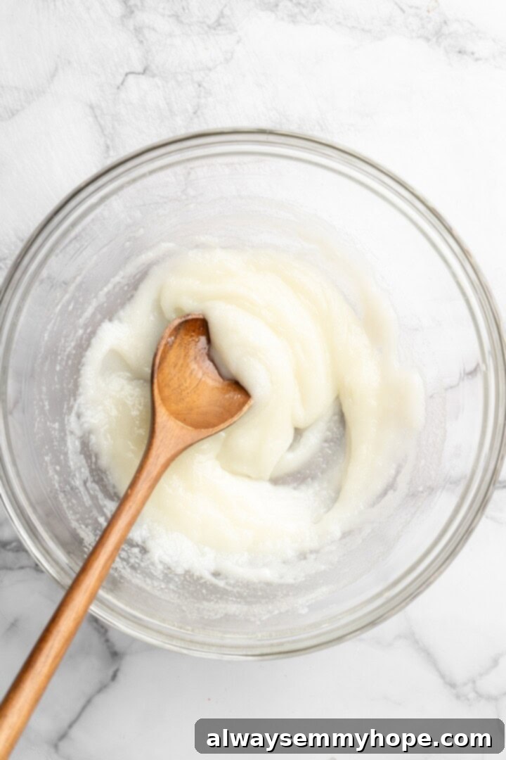 These easy carrot cake muffins bake up in just 30 minutes and are absolutely fantastic. Moist, delectable, vegan and gluten-free! Stirring oil, yogurt, and sugar in bowl