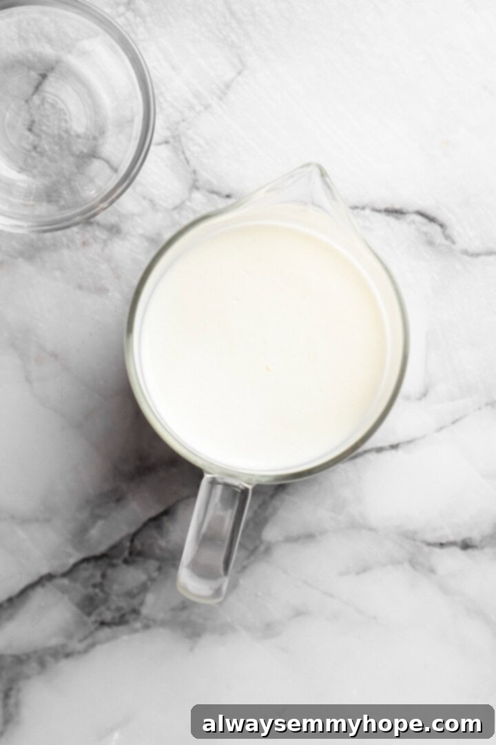 These easy carrot cake muffins bake up in just 30 minutes and are absolutely fantastic. Moist, delectable, vegan and gluten-free! Vegan buttermilk in measuring cup