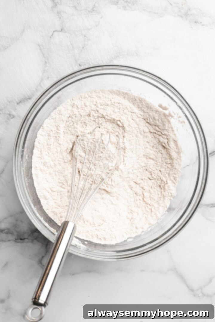 These easy carrot cake muffins bake up in just 30 minutes and are absolutely fantastic. Moist, delectable, vegan and gluten-free! Whisking dry ingredients in bowl