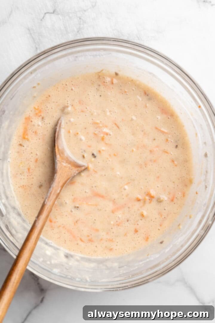 These easy carrot cake muffins bake up in just 30 minutes and are absolutely fantastic. Moist, delectable, vegan and gluten-free! Stirring mix-ins into muffin batter