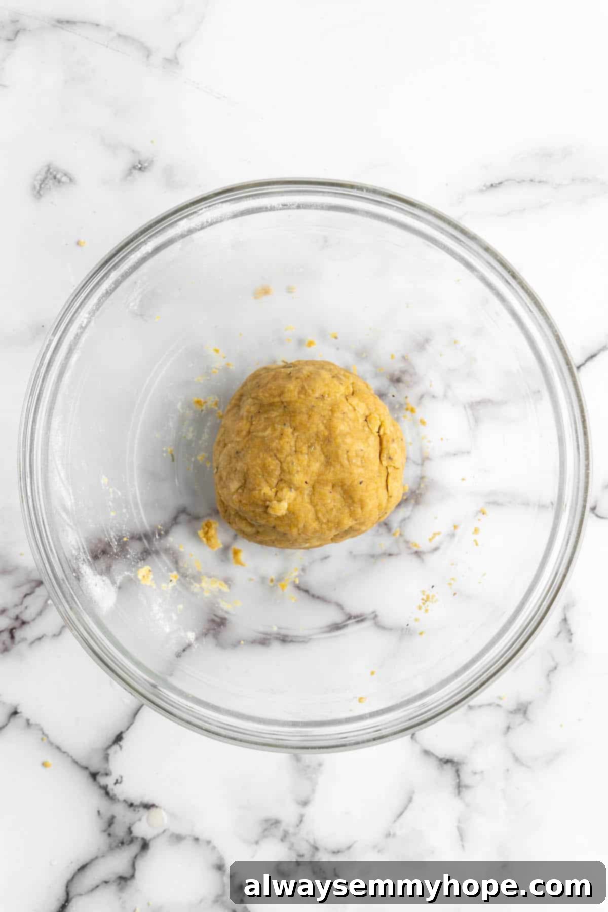 These vegan Cheez-Its are crispy, crunchy, snackable, and super cheesy! Make your own homemade vegan cheese crackers in just 30 minutes. Vegan cheez-it dough in glass bowl