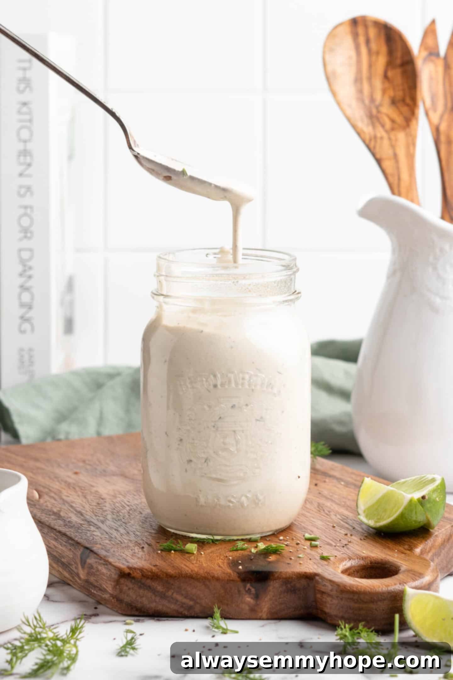 Spoon drizzling vegan ranch dressing into jar