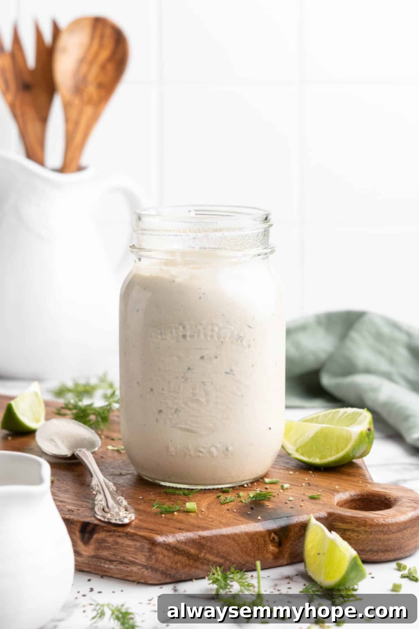 Jar of vegan ranch dressing on wood cutting board