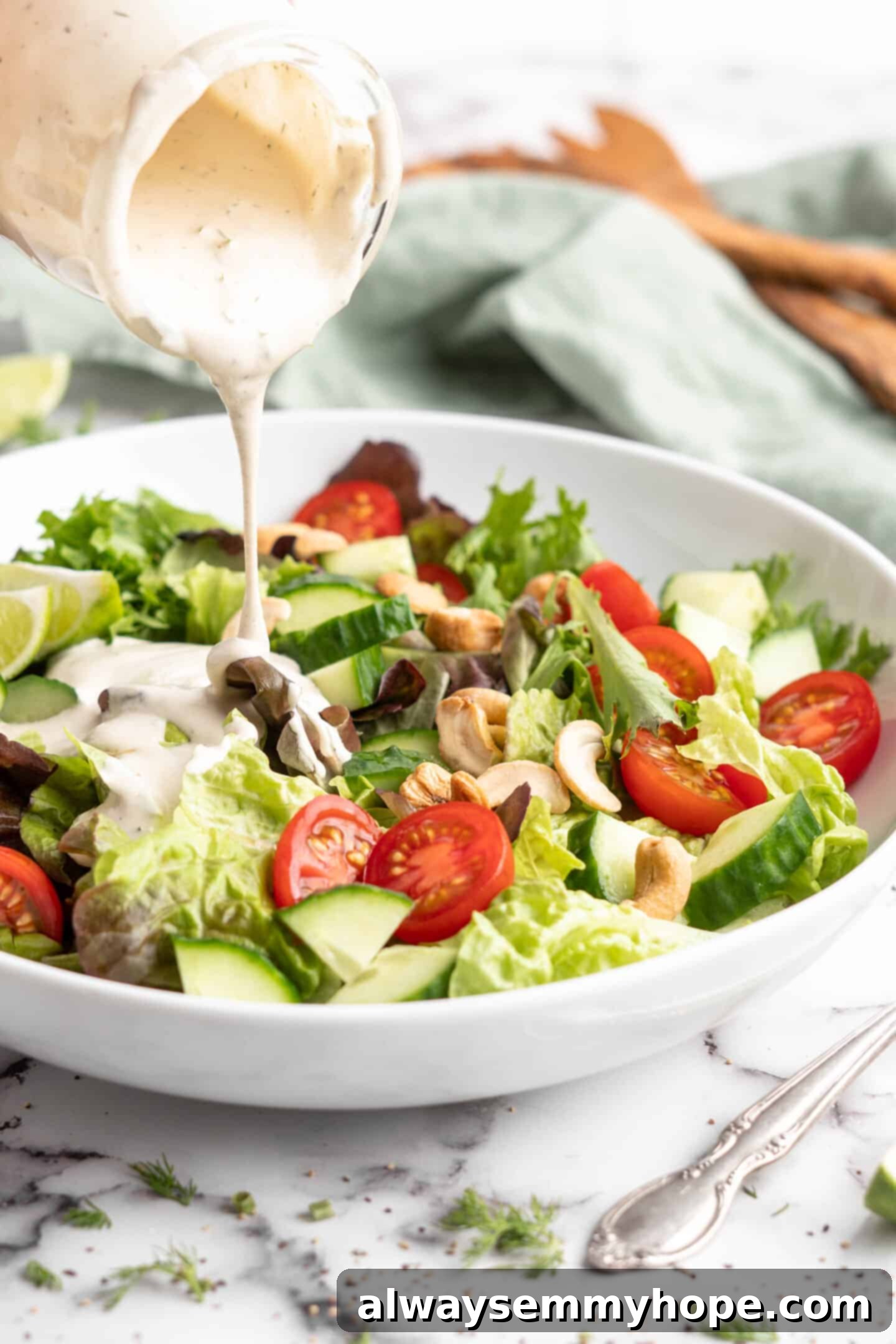 Pouring vegan ranch dressing onto salad