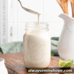 Spoon drizzling vegan ranch dressing into jar