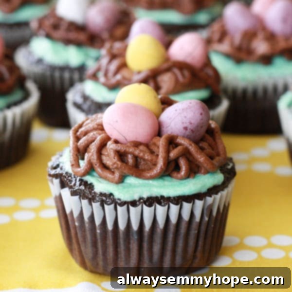 Cute Bird's Nest Easter Cupcakes. Easy to make and fun to eat, with chocolate Easter eggs to set them off. Close-up of three delightful bird's nest Easter cupcakes, artfully decorated with teal frosting, chocolate nests, and mini chocolate eggs, resting on a yellow tablecloth.