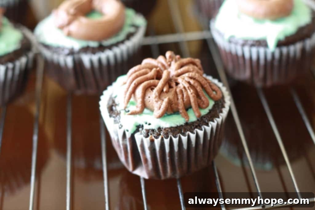 Cute Bird's Nest Easter Cupcakes. Easy to make and fun to eat, with chocolate Easter eggs to set them off. Intricate thin lines of brown chocolate frosting creating a detailed nest texture on the cupcake.