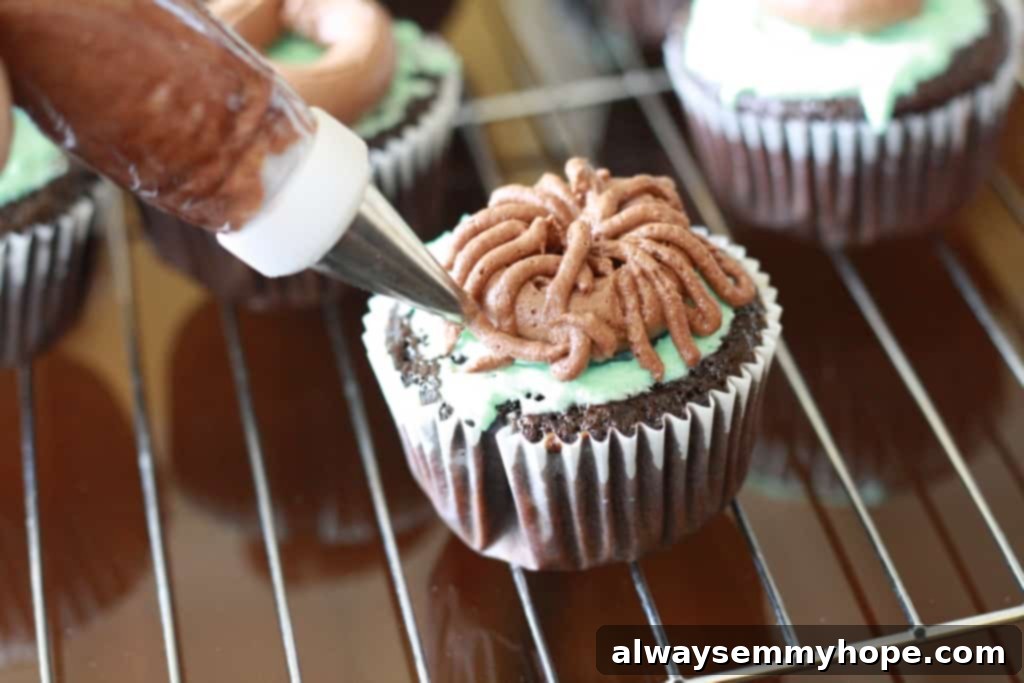 Cute Bird's Nest Easter Cupcakes. Easy to make and fun to eat, with chocolate Easter eggs to set them off. Final stage of making a bird's nest shape on top of a cupcake with chocolate frosting, showing layers of piped 'twigs'.