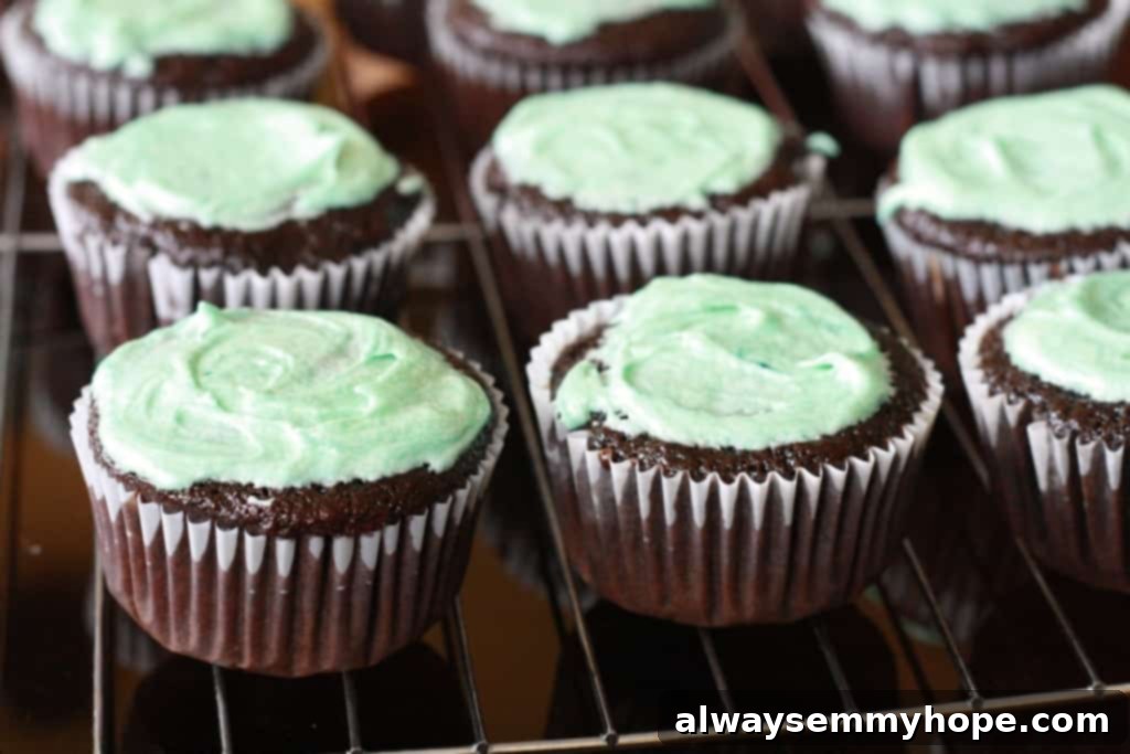 Cute Bird's Nest Easter Cupcakes. Easy to make and fun to eat, with chocolate Easter eggs to set them off. Cupcakes frosted with bright green teal frosting, ready for the chocolate nest decoration.